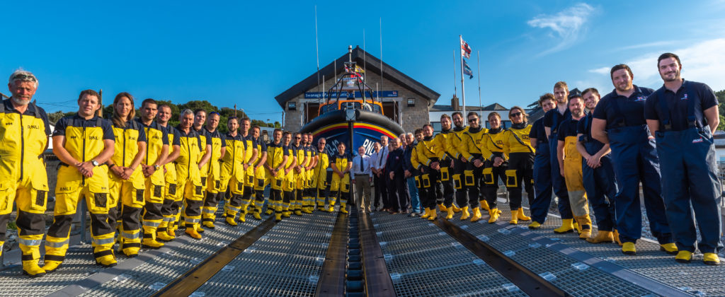 Swanage Lifeboat crew standing outside the Lifeboat house