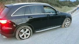 Car with burst tyres in Studland