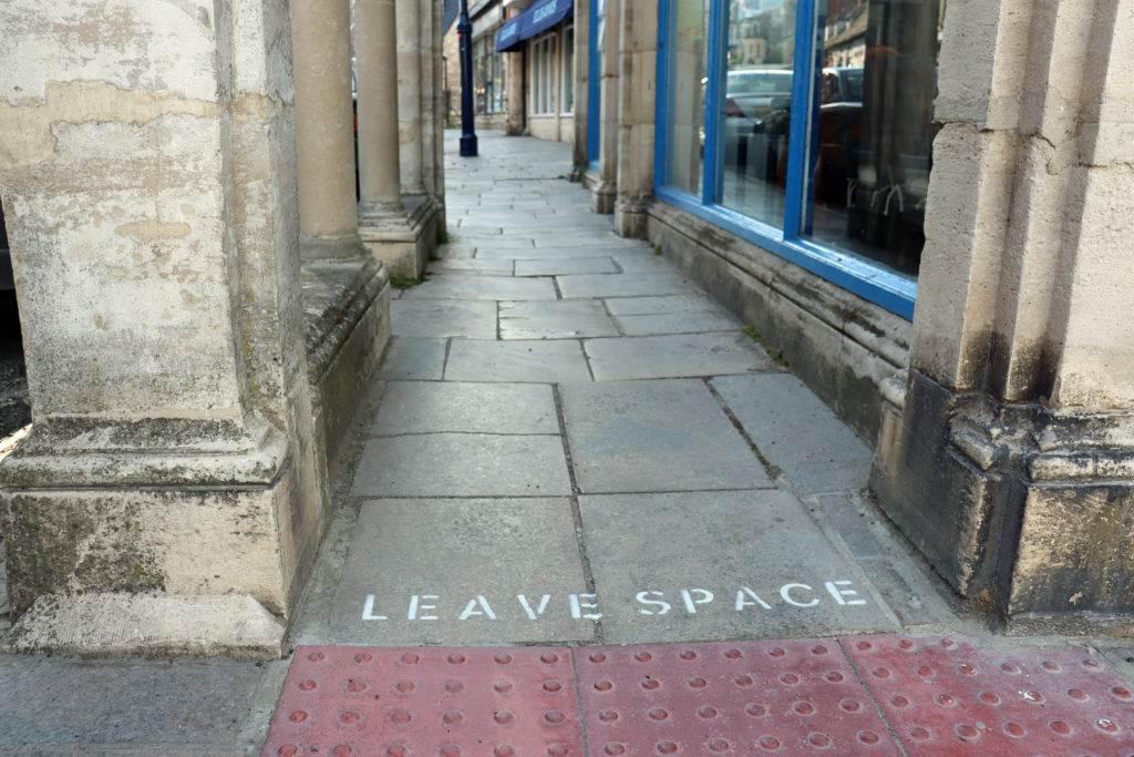 'Leave space' sign on a pavement