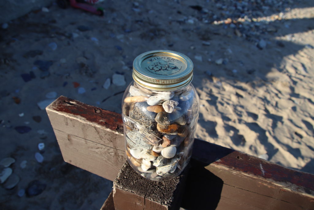 Jar filled with pebbles and shells