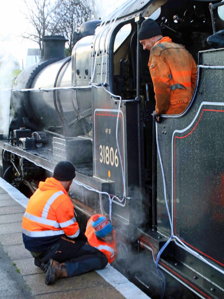 Lights being added by crew to train at Swanage Station