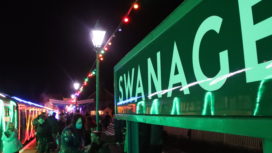 Swanage sign at Swanage station with festive lights