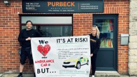 Purbeck Media staff with campaign banner