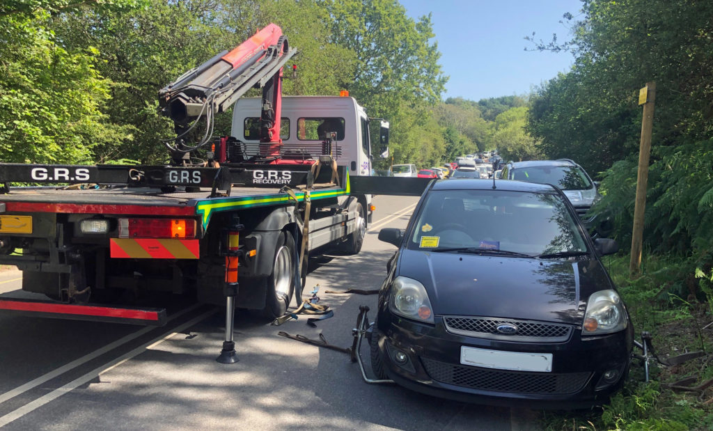Car being removed by tow truck from Ferry Road in Studland (