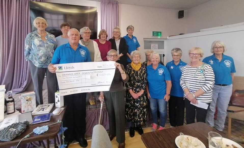 Naughty Knitters hand over cheque to dementia charity