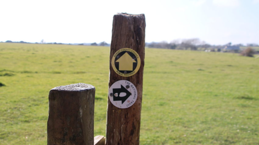 Footpath markers on wooden stile