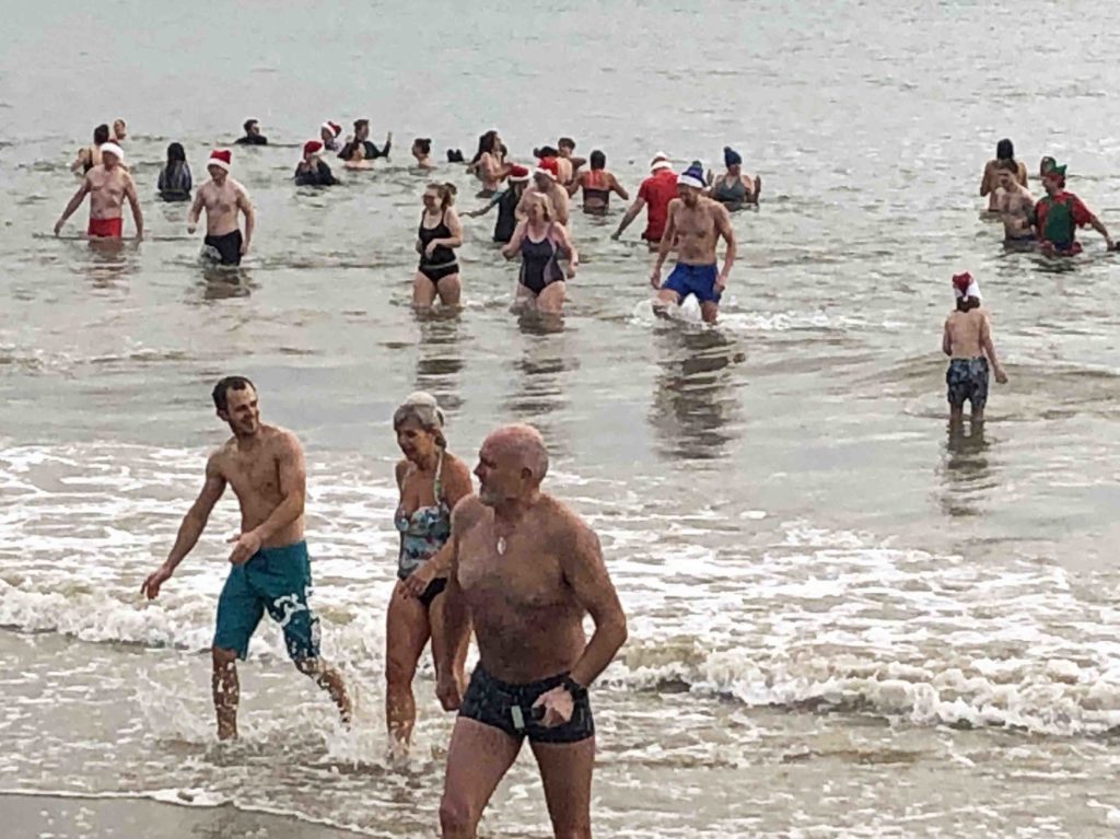 Swimmers in the sea for a Boxing Day swim in Swanage Bay