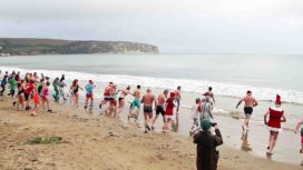 Swimmers in the sea for a Boxing Day swim in Swanage Bay