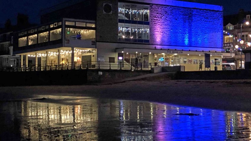 Exterior of The Mowlem lit up in blue