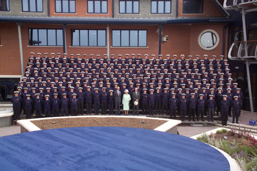 HM The Queen at the Lifeboat College opening in Poole.  The group photo is of all the RNLI crew members (Coxswains) from the whole of the UK.  The Duke of Edinburgh and the Duke of Kent are stood at either side of Her Majesty.  
