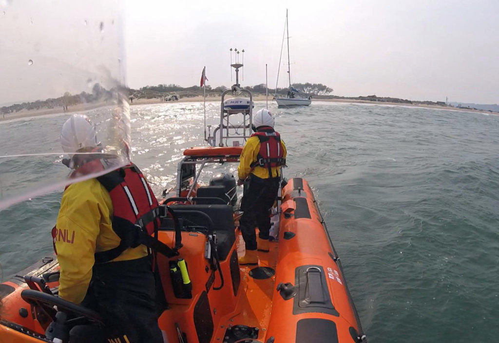 RNLI rescue yacht gone aground at Shell Beach in Studland