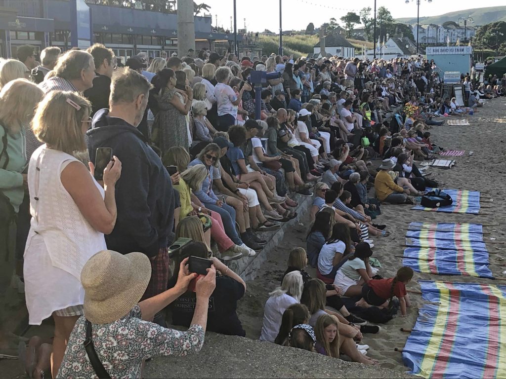 Audience at SW!M show performance on Swanage Beach