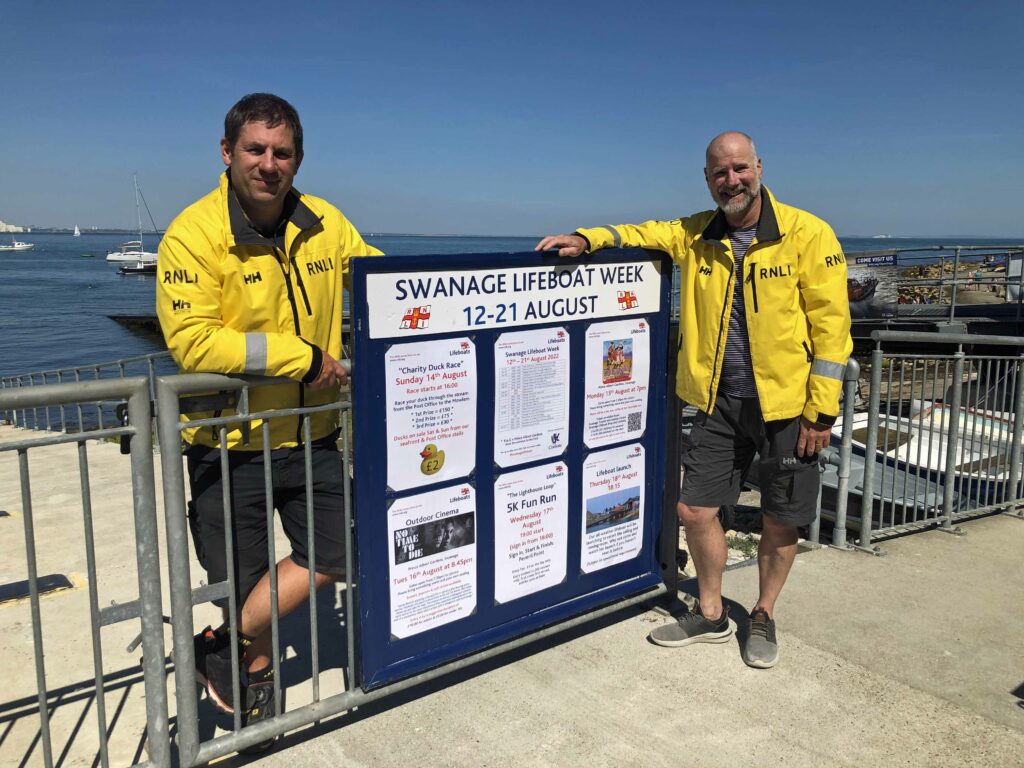 Dave Turrnbull and Steve Williams with Lifeboat week 2022 sign