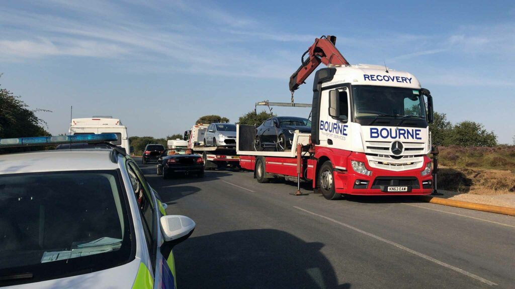 Cars get towed along Ferry Road in Studland