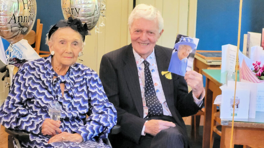 Margaret and Peter Brayshaw at their platinum wedding anniversary with a card from the late Queen