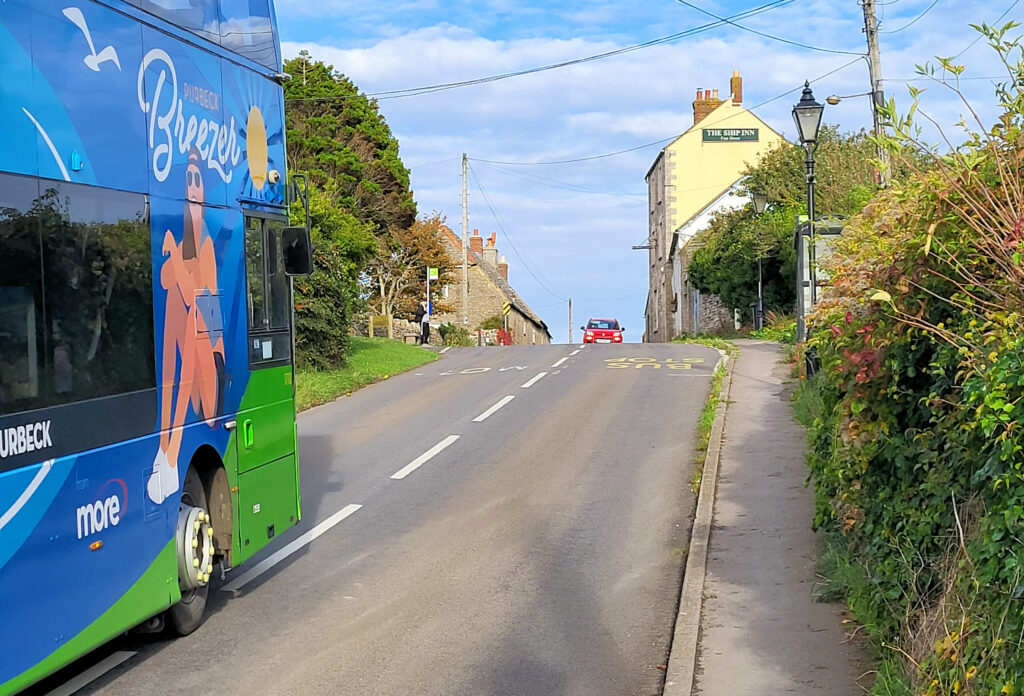 A bus goes through Village lanes at Langton Matravers