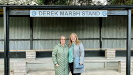 Derek Marsh stand at football ground with his daughters