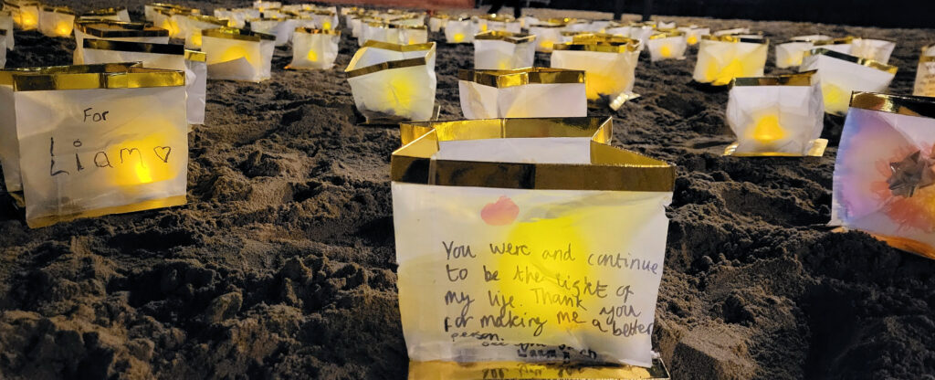 Candles on Swanage beach in memory of friends and family who have passed on