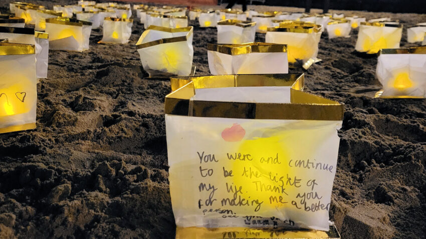 Candles on Swanage beach in memory of friends and family who have passed on