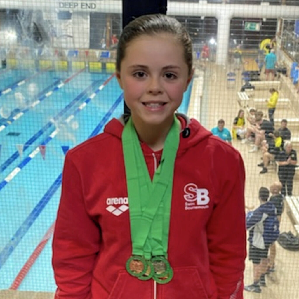 Daisy Dorset County swimming champion with her medals