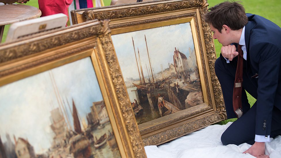 Antiques roadshow expert examines paintings