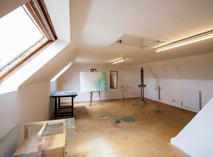 A light and spacious art studio fills the second floor of the former church