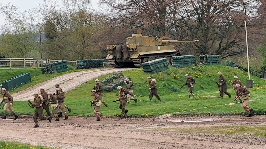 British troops advance during a reenactment of the capture of Tiger tank 131 at Bovington Museum