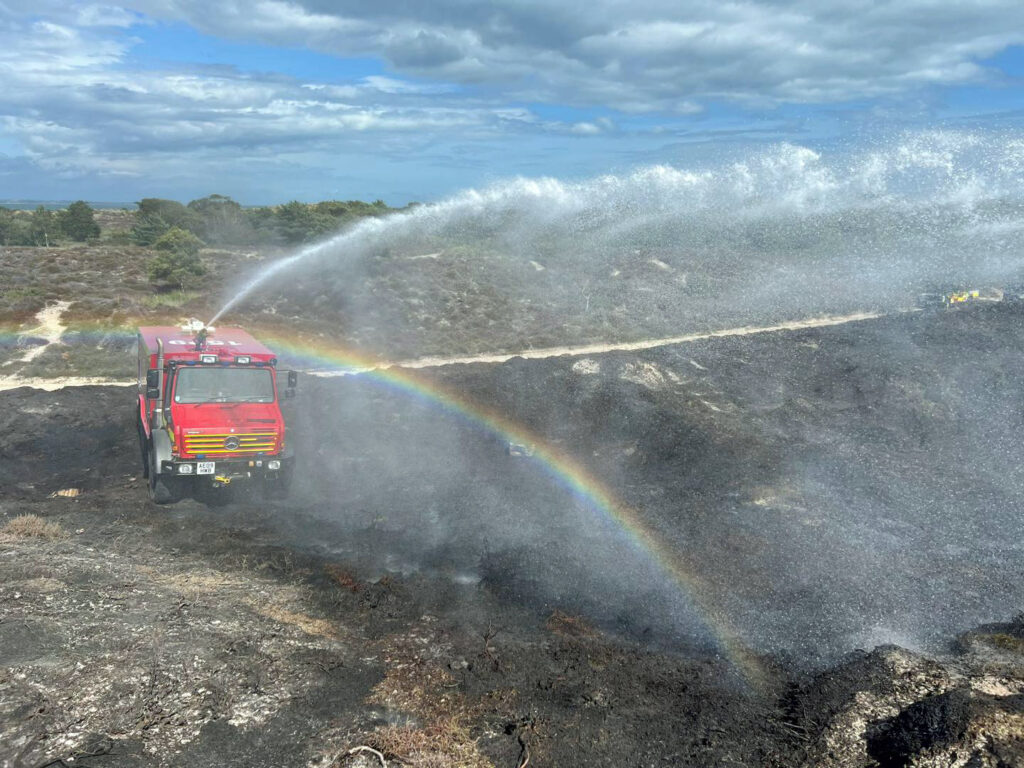 Firefighters tackling a fire in Studland