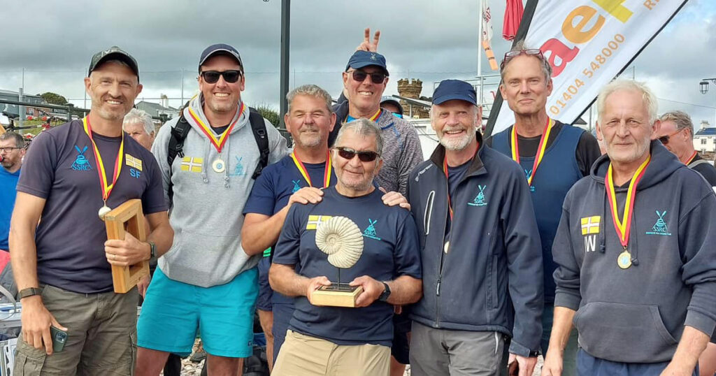 Gig rowing Mens B crew winning the Jurassic League Cup at Sidmouth in August 2023