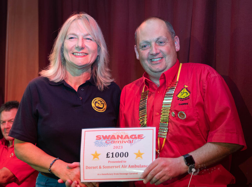 Linda Hernandez from Dorset and Somerset air ambulance collects cheque from Swanage Carnival