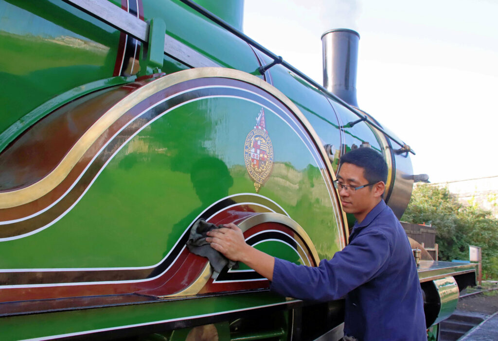 Nathan Au gives the locomotive a final polish before its first steaming in 75 years