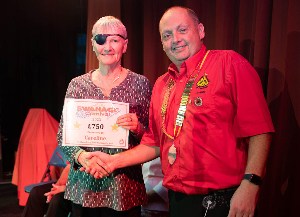 Val Hodge receives cheque for Careline from Swanage Carnival 2023