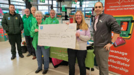 Swanage Co-op manager Simon Lightburn, far right, with the store's £24,000 cheque shared between three local groups
