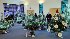 Hand made decorations on sparkling branches at the Purbeck Christmas Tree Festival 2023