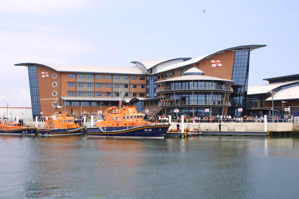 Poole Lifeboat College at the official opening for HM The Queen's visit. Crowds gathering in the background. In the foreground is the Severn all weather lifeboat 17-44, ON 1277 (Annette Hutton). Landscape
