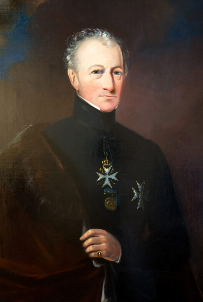 Painting of Colonel Sir William Hillary, Bt. Founder of the RNLI. Oil on canvas, half length portrait. Shown wearing the robes and cross of a Kinght of the Order of St John of Jerusalem, commonly known as a Knight of Malta. Artist unknown, English School, mid 19th Century.