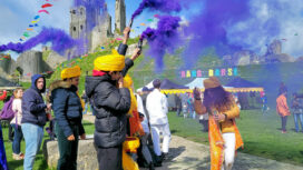 Plumes of purple smoke at Corfe Castle mark the official opening of Rang Barse, the Holi festival of colours