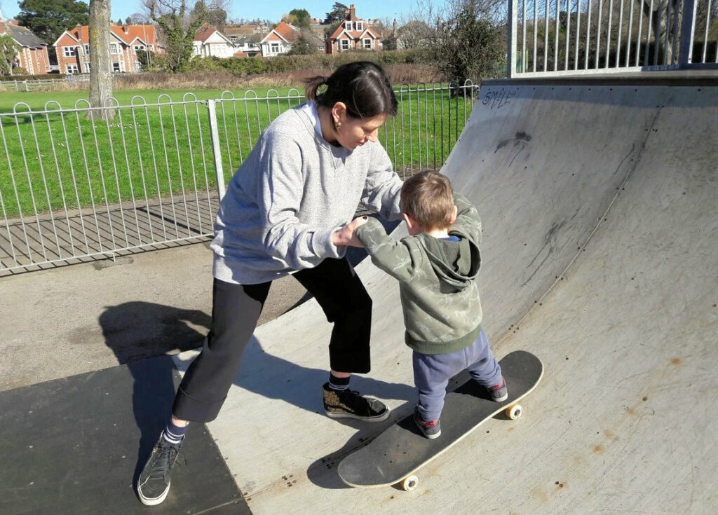 Two year old James has his first taste of skateboarding